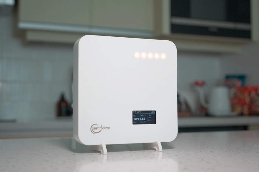 An AirGradient One sitting on a kitchen counter